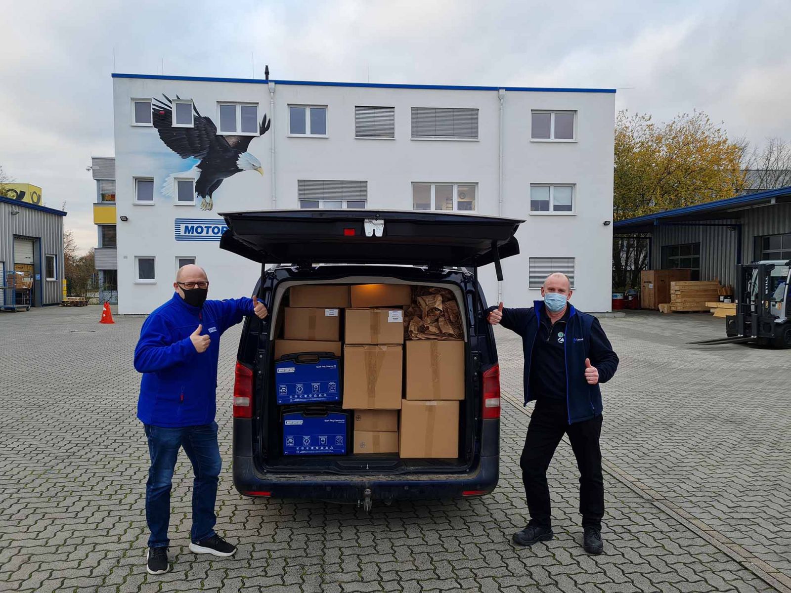 James Thompson of Gen-C (R) and Olaf Jeinrich of Motortech (L) load up Gen[C's van with Motortech components for the UK market